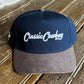 Blue and gray cap with 'Casual Cowboy' text on a wooden surface