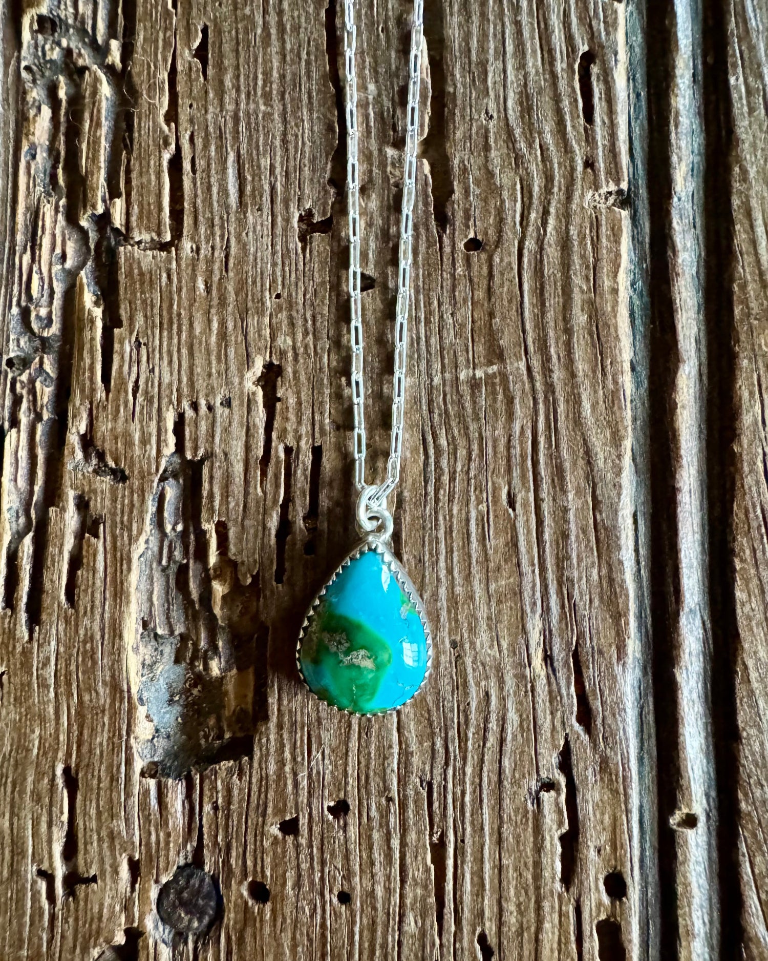 Turquoise pendant necklace on a wooden surface