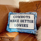 Decorative pillow with 'Cowboys Make Better Lovers' text on a brown couch.