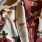Folded clothing items with floral patterns on a textured surface