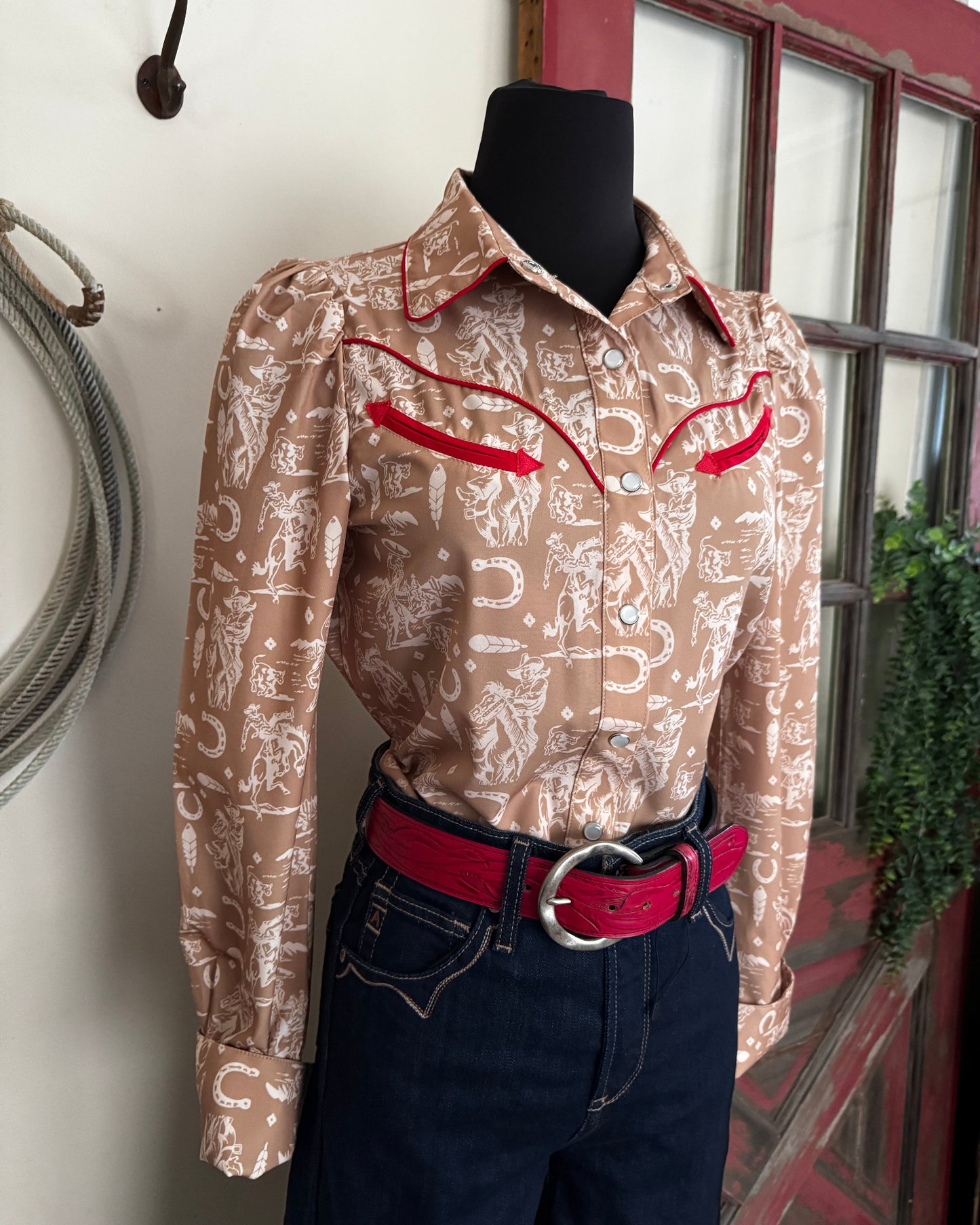 Brown patterned jacket with red accents on a chair indoors