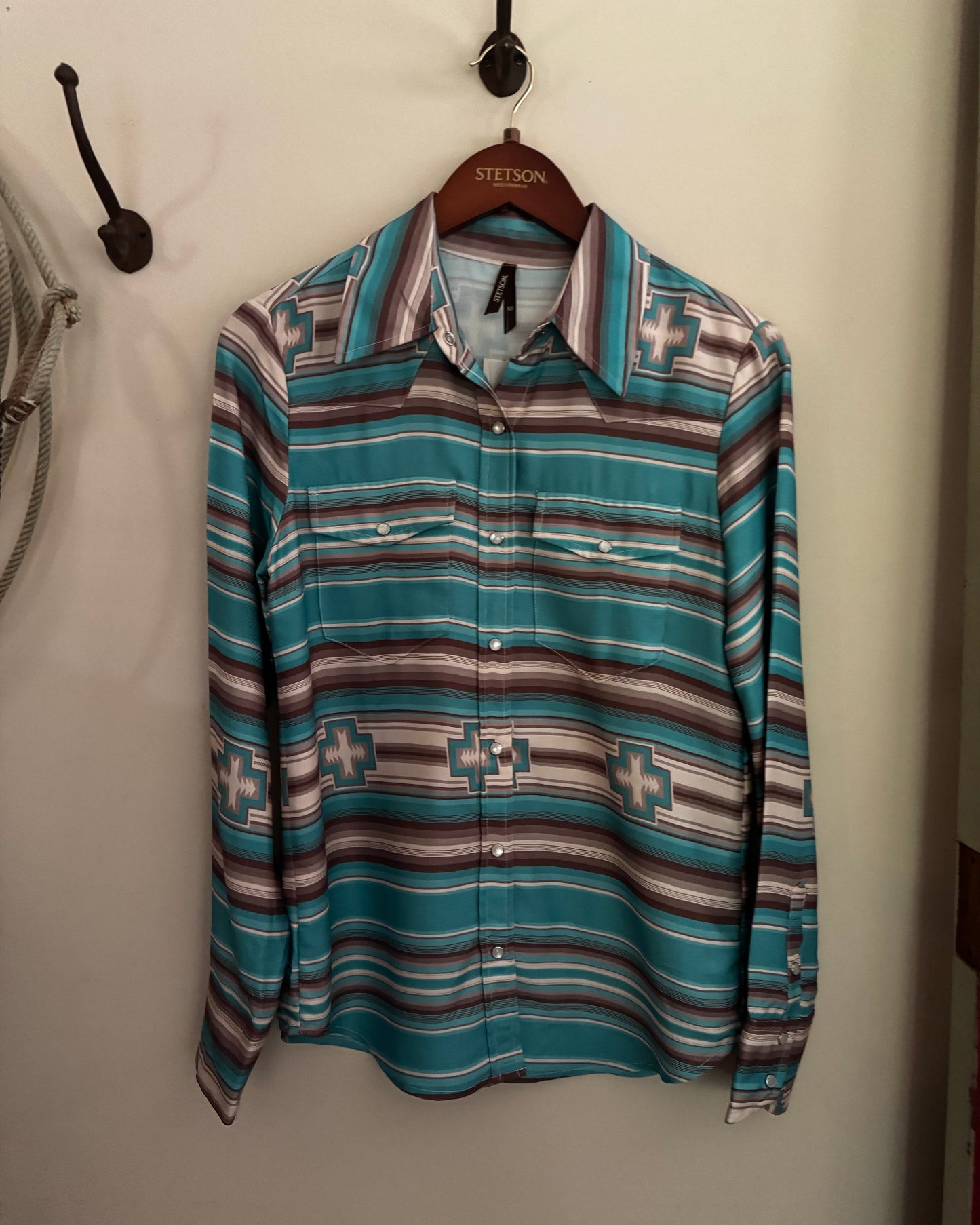 Folded patterned shirt on a white surface