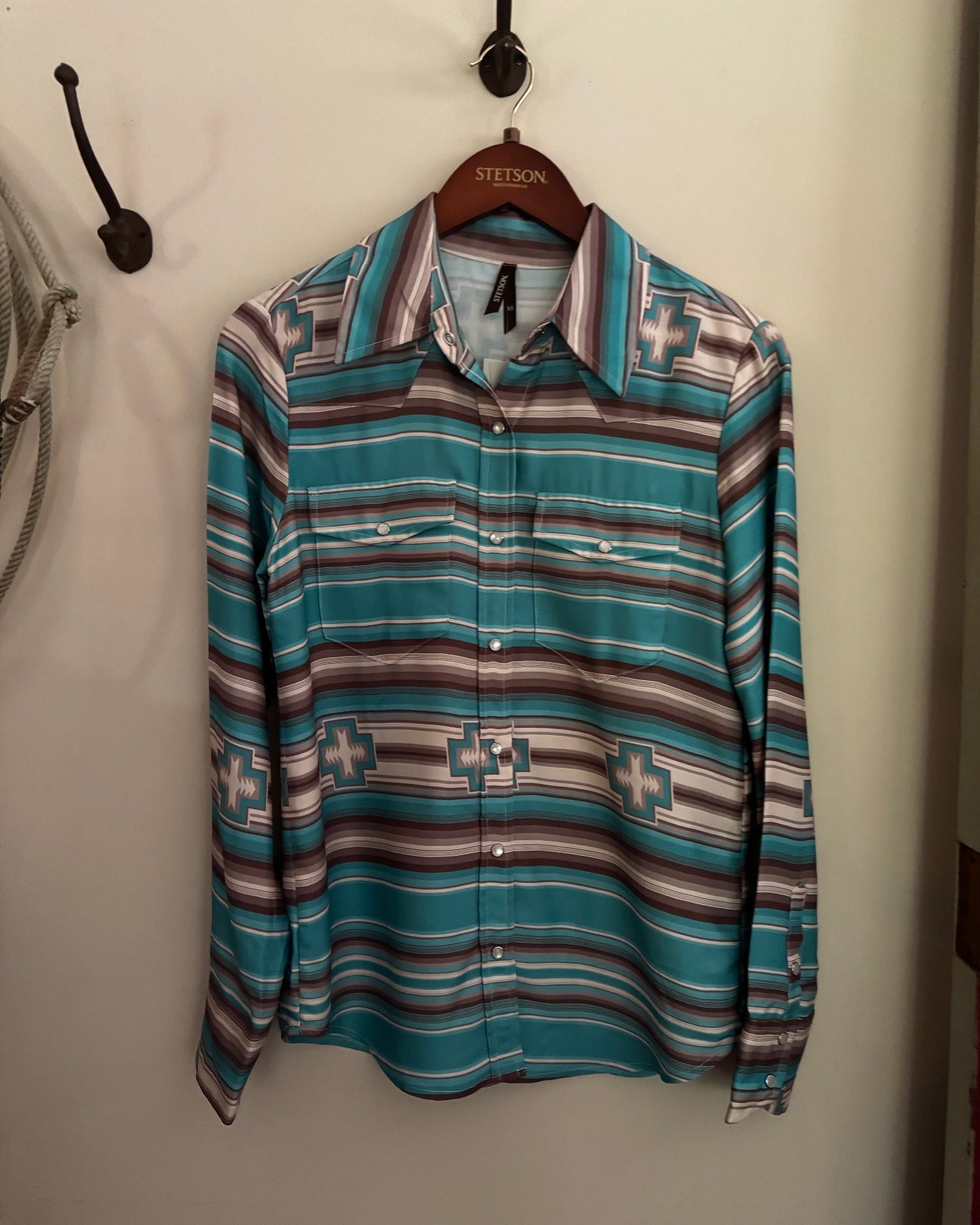 Folded patterned shirt on a white surface