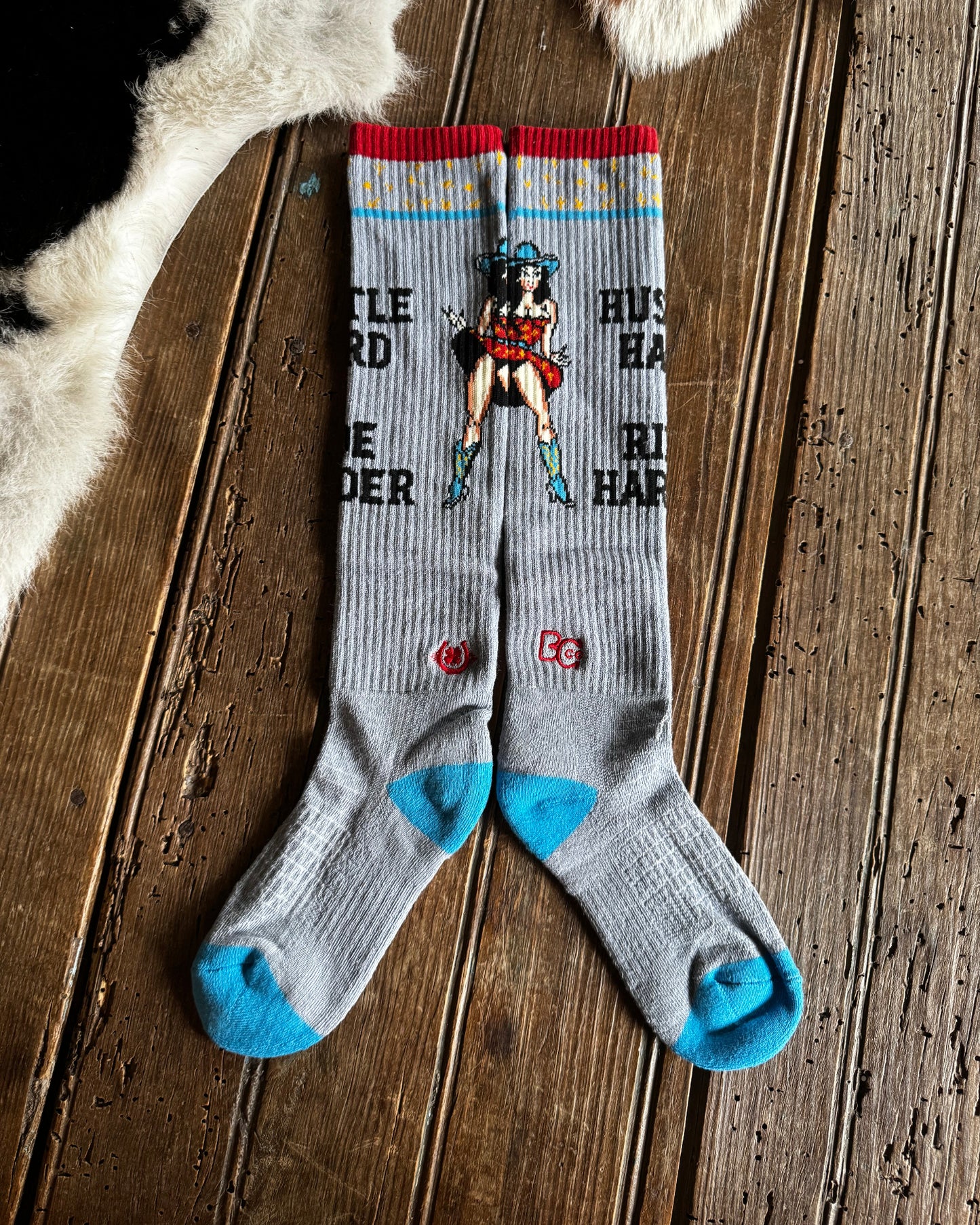 Gray socks with colorful design on a wooden surface