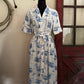 blue and white dress in front of a red door