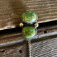 Pair of turquoise stone earrings on a wooden surface