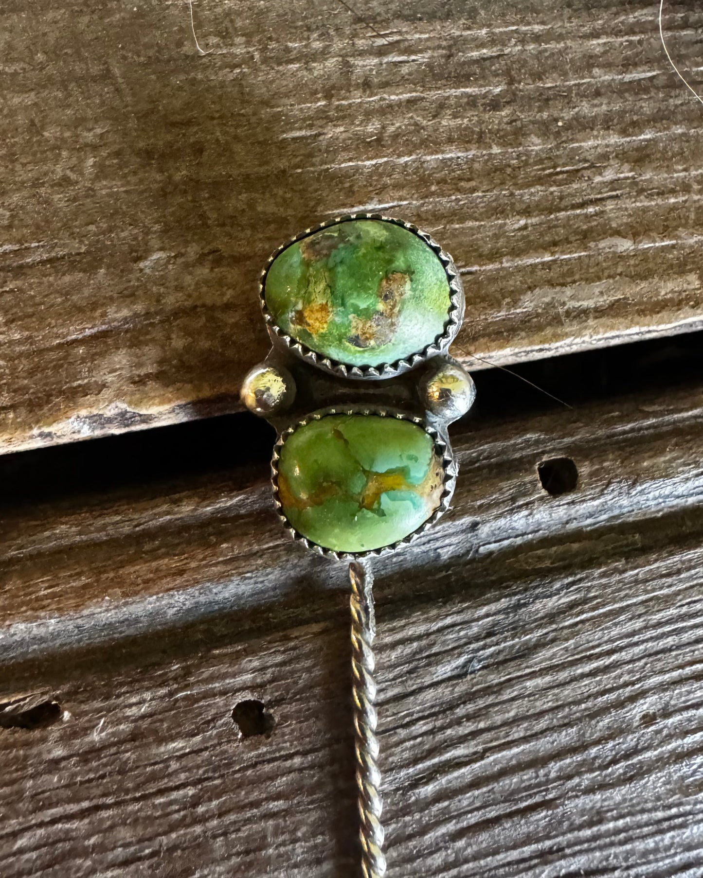 Pair of turquoise stone earrings on a wooden surface