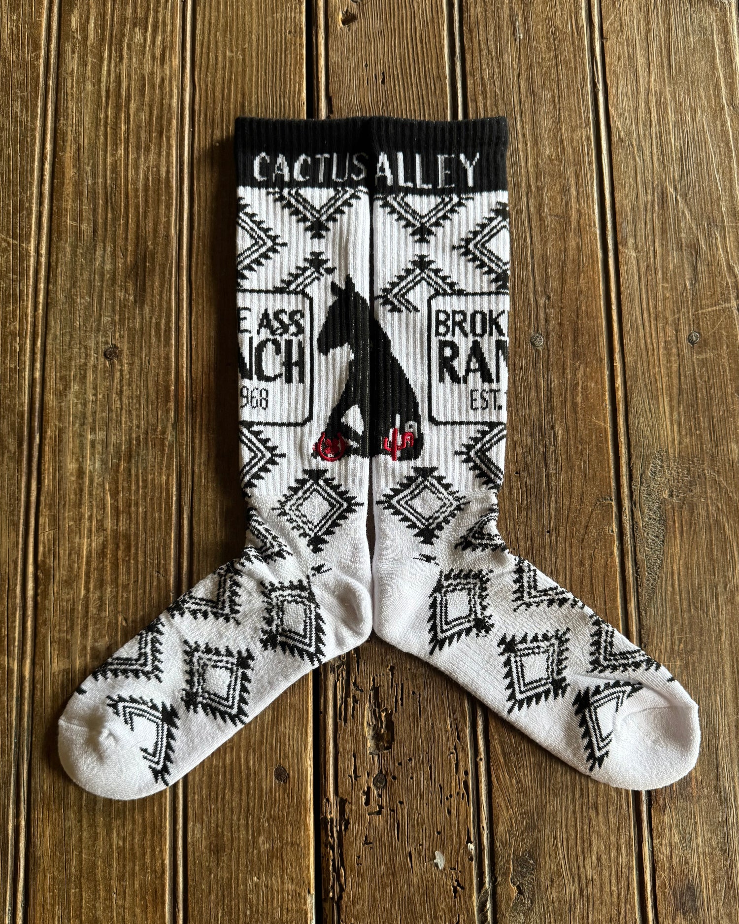 Cactus Alley - Broke A$$ Ranch Performance Socks (Black/White) on rustic wood background
