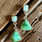 turquoise earrings on a rustic wooden background 