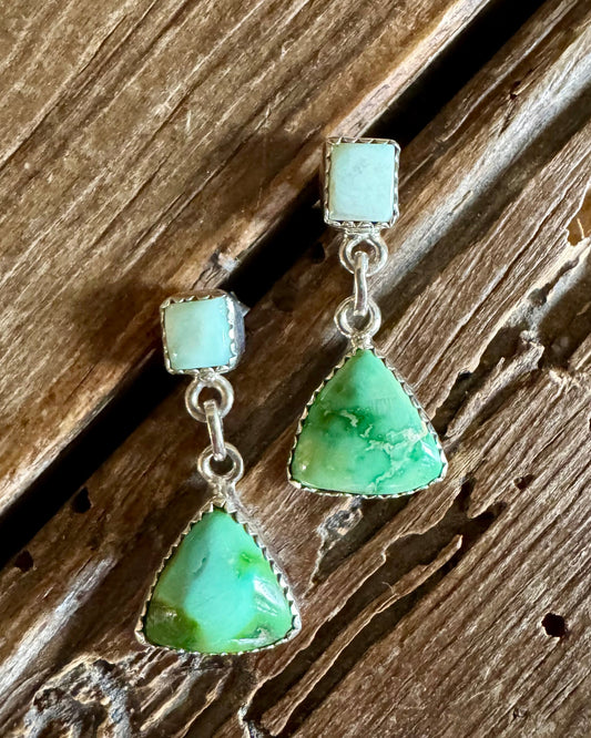 turquoise earrings on a rustic wooden background 