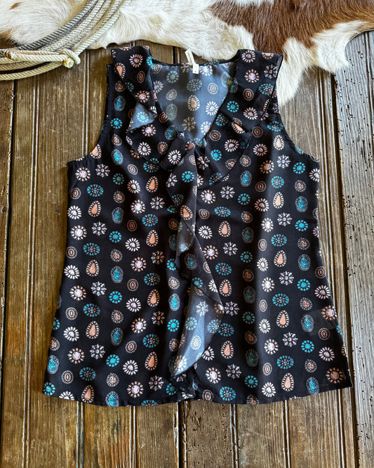 Black patterned fabric on a wooden surface with cowhide rug