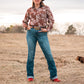 model standing in field wearing a fashionable modern western outfit