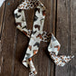 leopard and horse print twilly scarf on a wooden background
