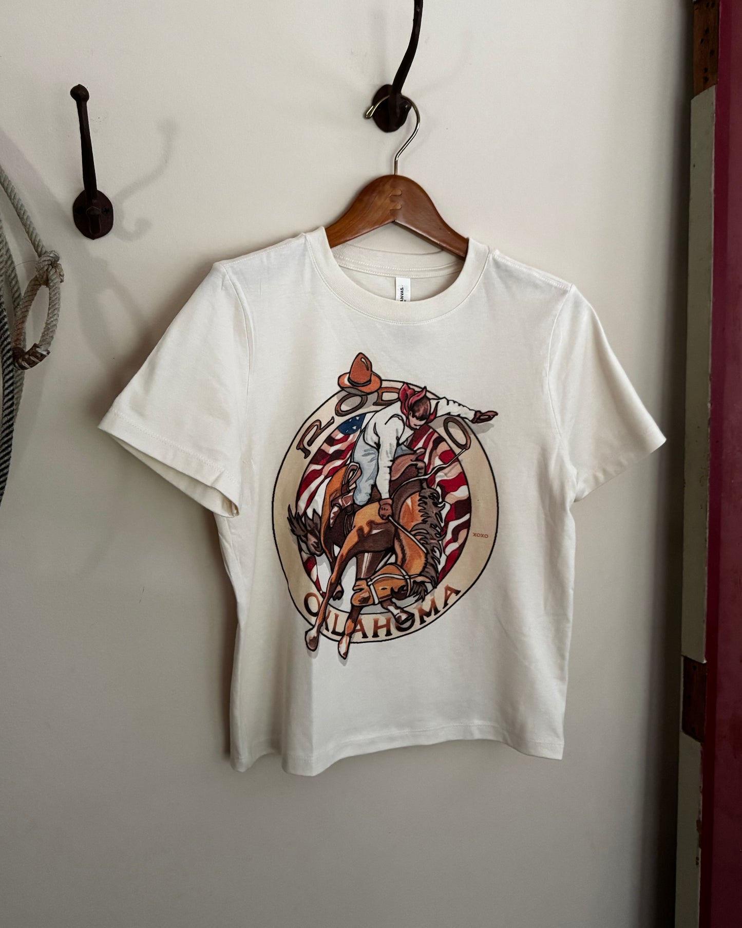 White t-shirt with a colorful graphic design on a white surface