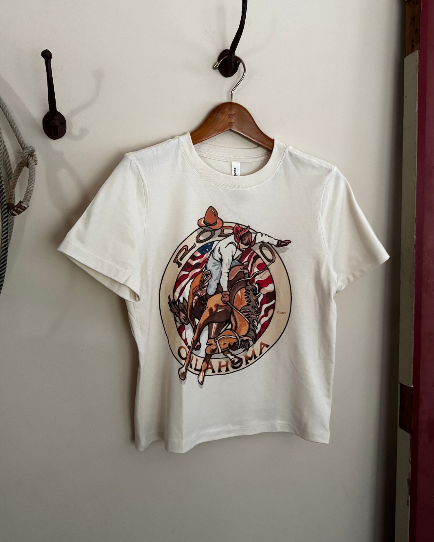 White t-shirt with a colorful graphic design on a white surface