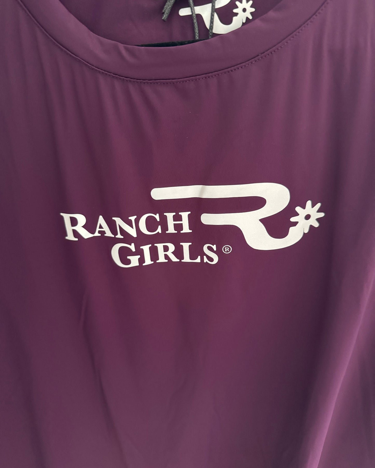 Close-up of a purple garment with 'Ranch Girls' logo