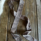 Zebra-striped bow tie on a wooden surface