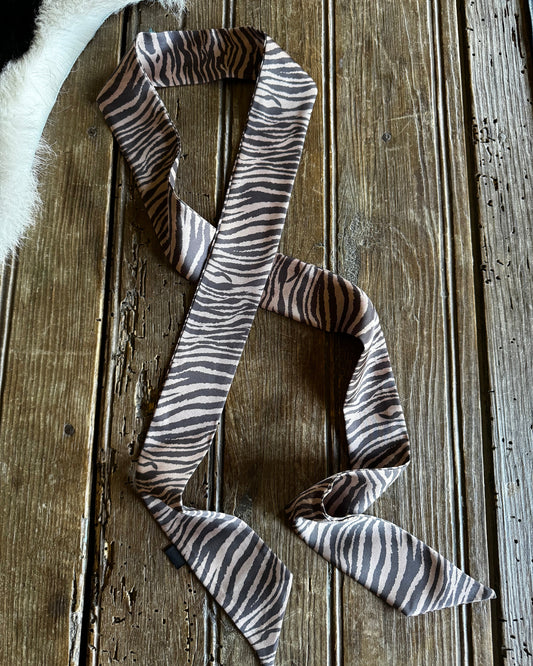 Zebra-striped bow tie on a wooden surface