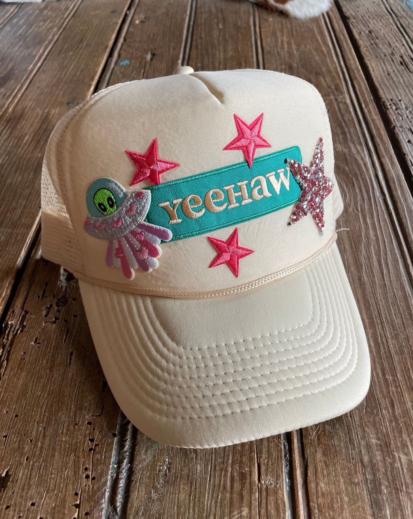 An Alien Yeehaw Trucker hat with custom patches