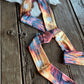 Colorful ribbon scarf on a wooden surface