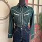Green western-style shirt with white accents on a mannequin against a neutral background