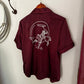 Maroon shirt with white graphic design on a white surface