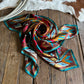 scarf folded on a rustic wood background with a cowhide and rope