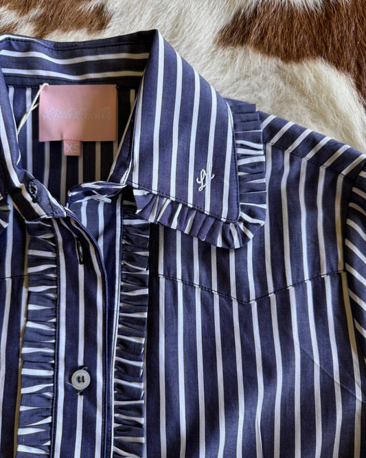 Close up of Ivy Pinstripe Frill Shirt on cowhide background