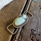 Necklace with a blue stone pendant on a wooden surface