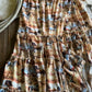Textured fabric with earthy tones on a wooden surface