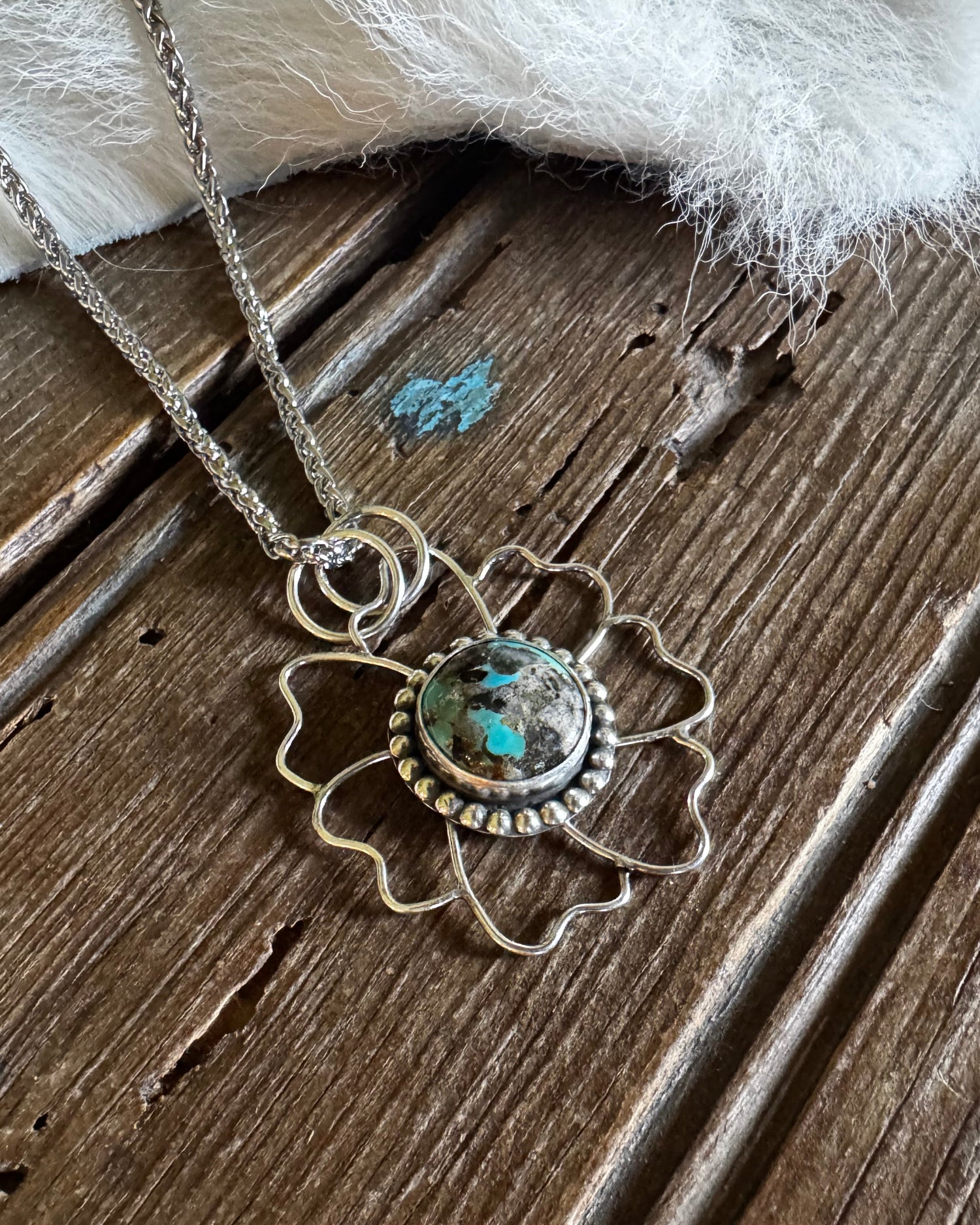 Necklace with a decorative pendant on a wooden surface