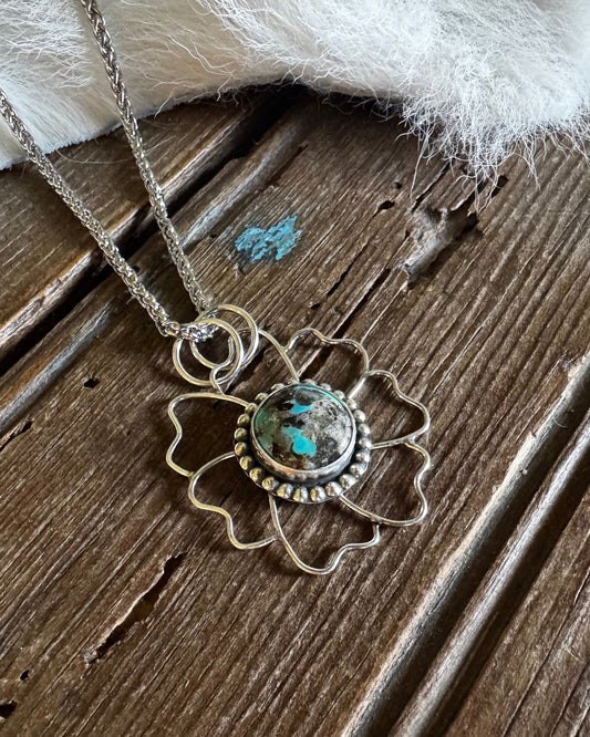 Necklace with a decorative pendant on a wooden surface