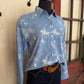 Mannequin wearing a blue patterned shirt with jeans against a neutral background