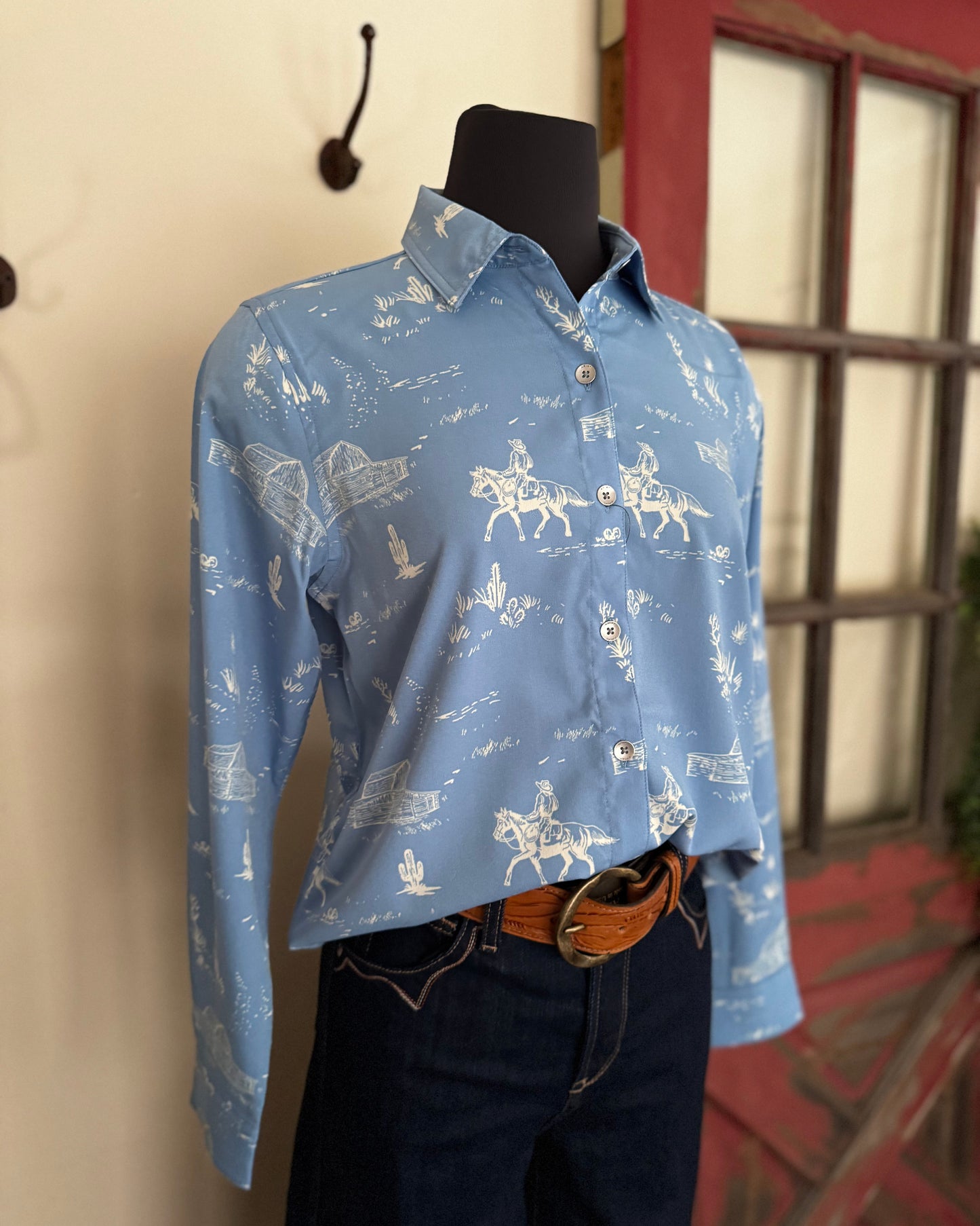 Mannequin wearing a blue patterned shirt with jeans against a neutral background