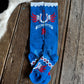 Blue socks with red and white designs on a wooden surface