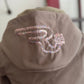 Brown jacket with decorative lettering on the back against a neutral background