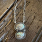 Necklace with two oval stones on a wooden surface