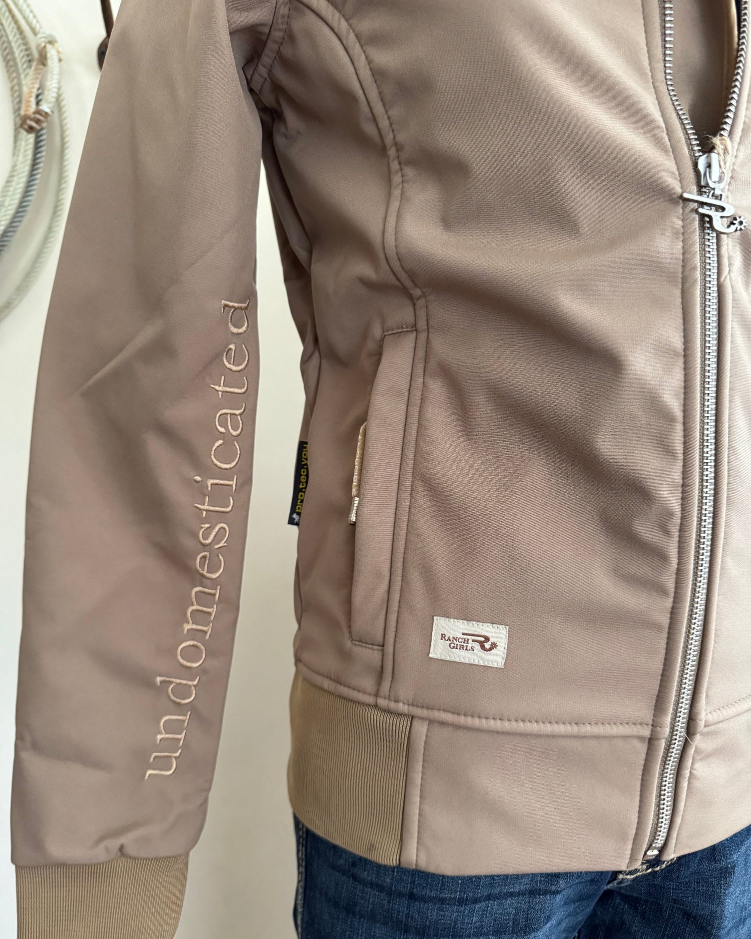 Brown jacket with a brand logo on a white surface