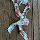 Floral patterned ribbon scarf on a wooden surface