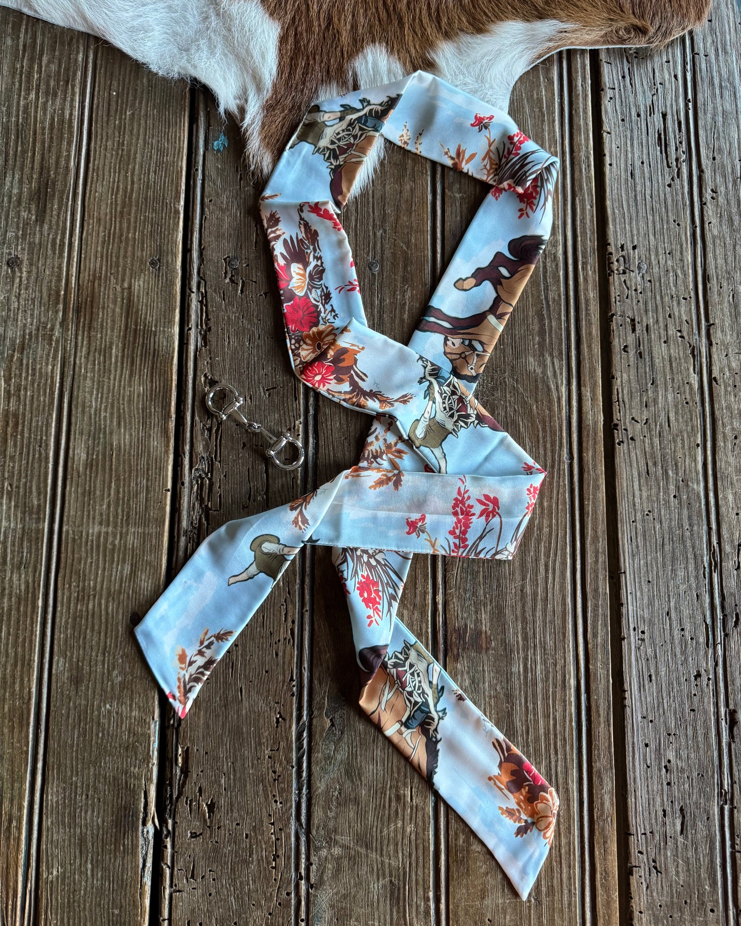 Floral patterned ribbon scarf on a wooden surface