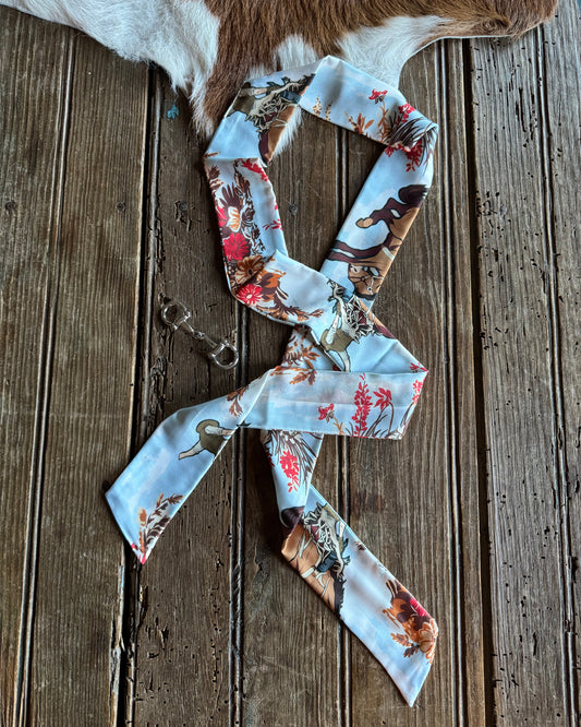Floral patterned ribbon scarf on a wooden surface