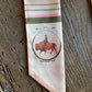 Close up of buffalo on a ribbon scarf on a rustic wood background 