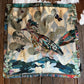 Scarf with nature-themed design on a wooden surface