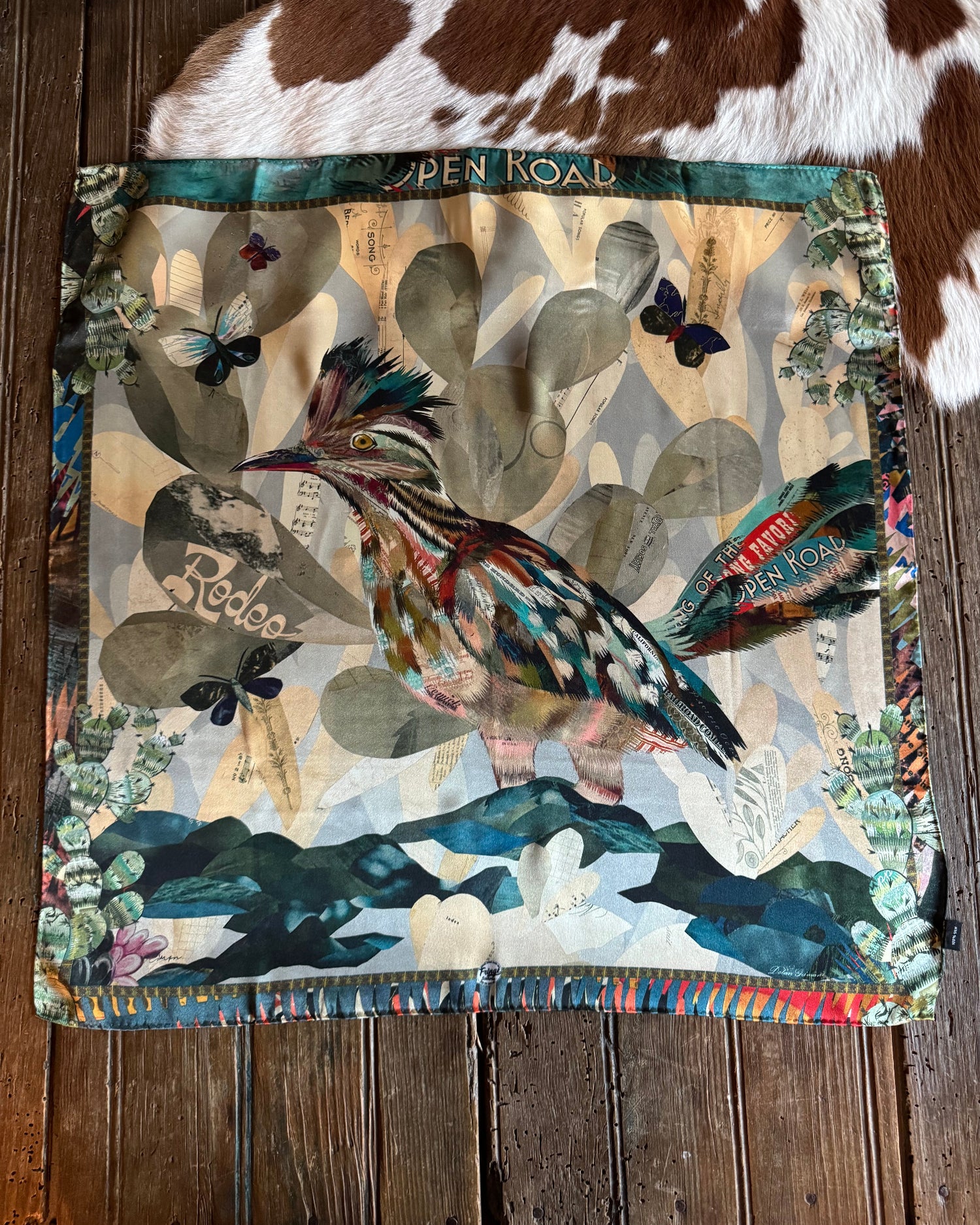 Scarf with nature-themed design on a wooden surface