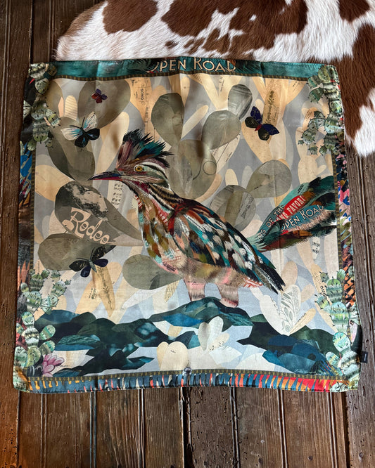 Scarf with nature-themed design on a wooden surface