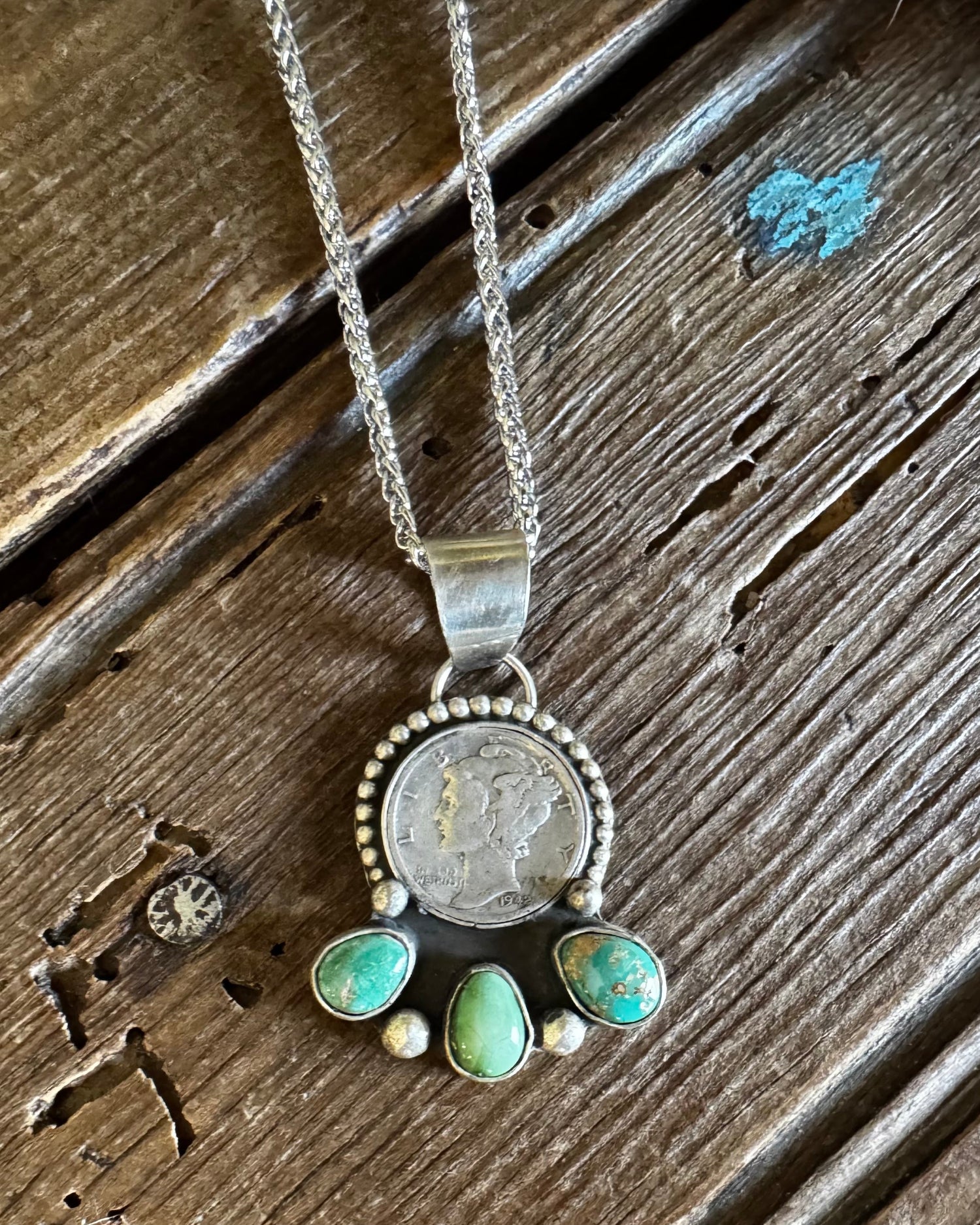 Dime necklace on a rustic wooden background