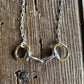 close up of Briarwood Snaffle Bit Necklace on rustic wood background 