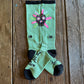 Don't Walk In Fear Performance Socks (Sage) showing design on rustic wood background 