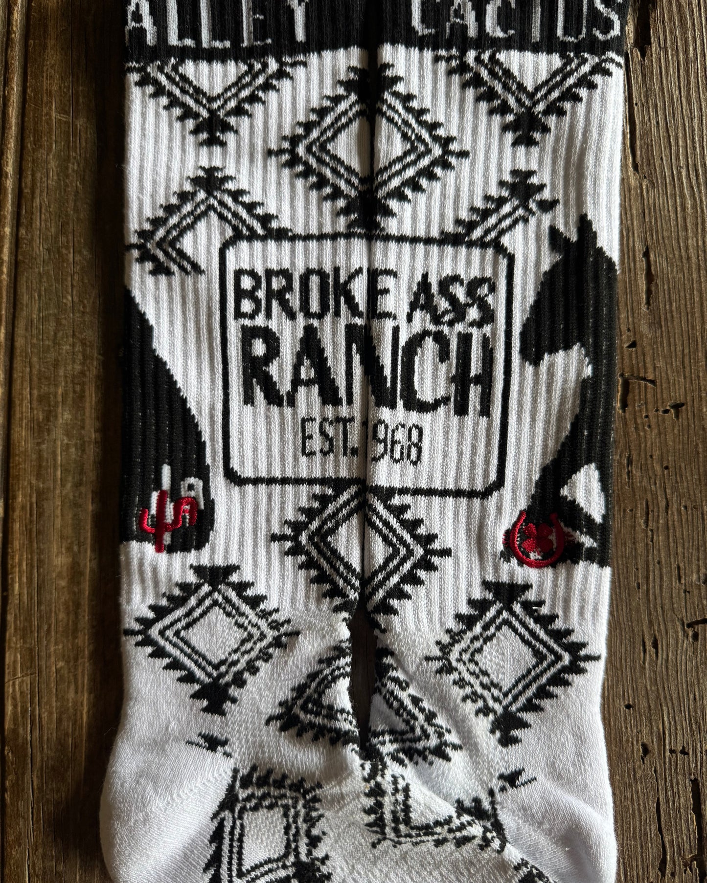 Cactus Alley - Broke A$$ Ranch Performance Socks (Black/White) on rustic wood background