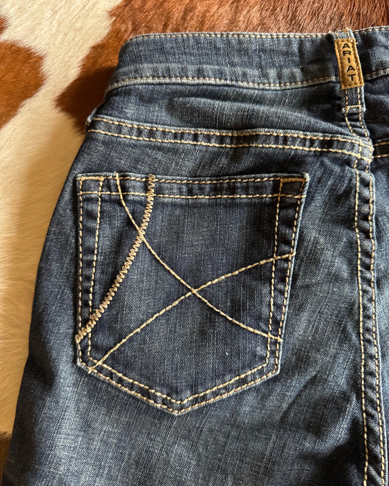 close up of pocket on Ella High Rise Slim Trouser Jeans on cowhide background 